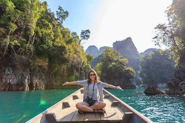 a woman on a boat spreading her arms